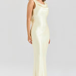 Model wearing pale yellow satin cowl neck maxi dress with elegant draping and sleek silhouette — House of CB | Endless UAE