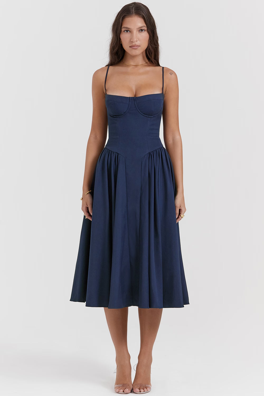 Woman wearing navy blue corset sundress with sweetheart neckline in garden setting — House of CB | Endless UAE