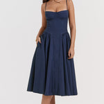 Woman wearing navy blue corset sundress with sweetheart neckline in garden setting — House of CB | Endless UAE