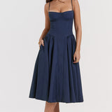 Woman wearing navy blue corset sundress with sweetheart neckline in garden setting — House of CB | Endless UAE
