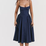 Woman wearing navy blue corset sundress with sweetheart neckline in garden setting — House of CB | Endless UAE