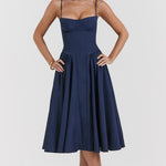 Woman wearing navy blue corset sundress with sweetheart neckline in garden setting — House of CB | Endless UAE