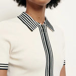 White knitted polo dress with black striped collar and trim details — Sandro | Endless UAE