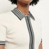 White knitted polo dress with black striped collar and trim details — Sandro | Endless UAE