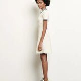White knitted polo dress with black striped collar and trim details — Sandro | Endless UAE