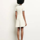 White knitted polo dress with black striped collar and trim details — Sandro | Endless UAE