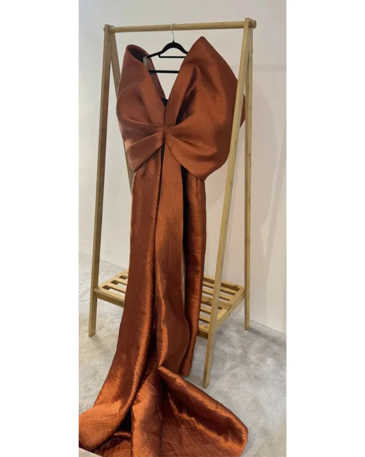 Woman wearing vibrant orange Grace 3D Shoulder Bow gown with dramatic back tail — Anaya Collection | Endless UAE