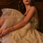 Woman wearing gold metallic lace tulle strapless midi gown with ruched waist — House of CB | Endless UAE