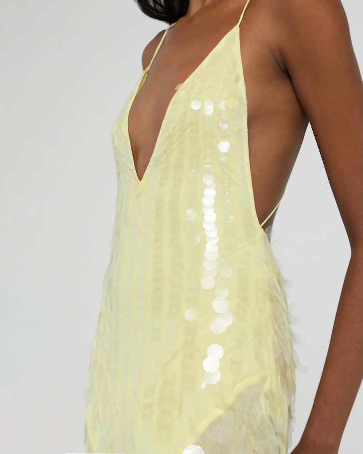 Woman wearing yellow sequined halter gown with flowing train and flower hair accessory — Rat & Boa | Endless UAE