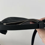 Black leather mini shoulder bag with textured finish held open to show interior — By Far | Endless UAE