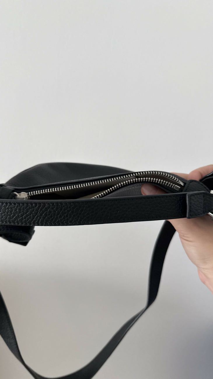 Black leather mini shoulder bag with textured finish held open to show interior — By Far | Endless UAE