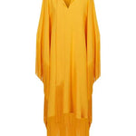 Woman wearing a yellow and orange fringed kaftan with black bag and sandals — Taller Marmo | Endless UAE