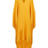 Woman wearing a yellow and orange fringed kaftan with black bag and sandals — Taller Marmo | Endless UAE