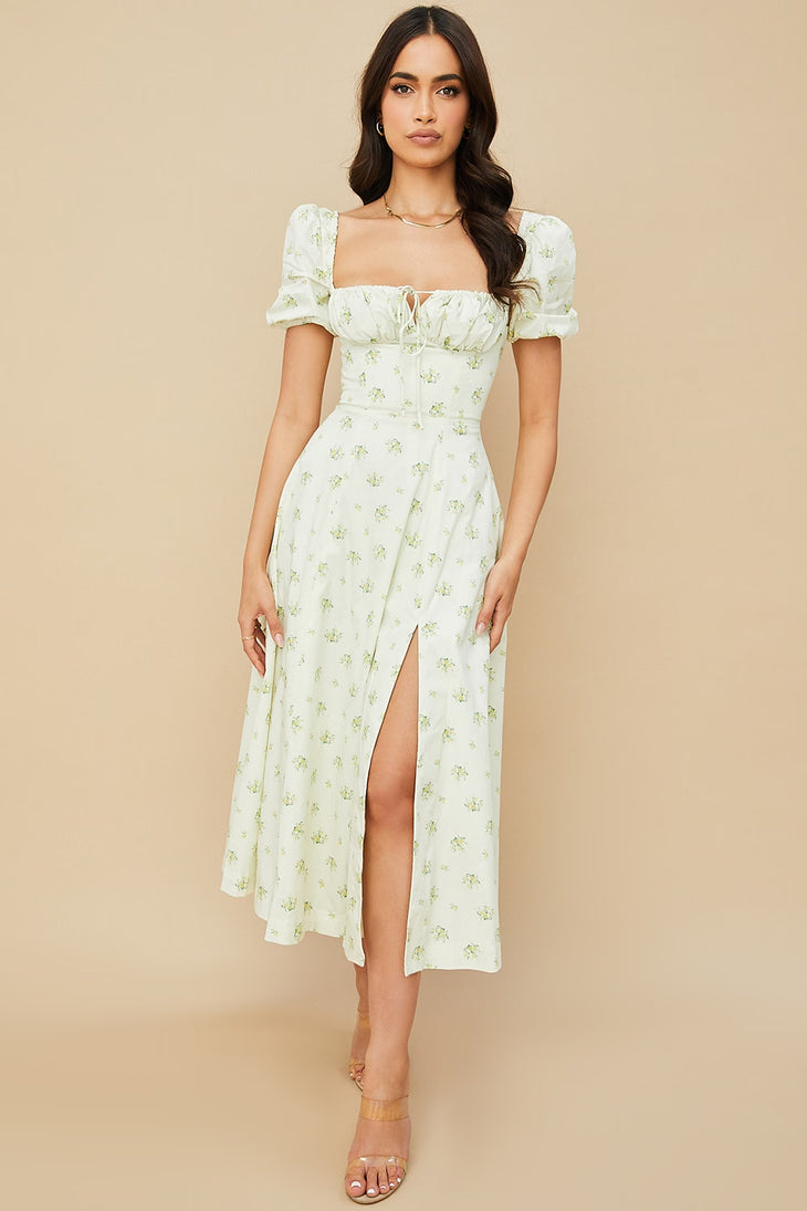 Woman wearing ivory floral puff sleeve midi dress with thigh slit — House of CB | Endless UAE