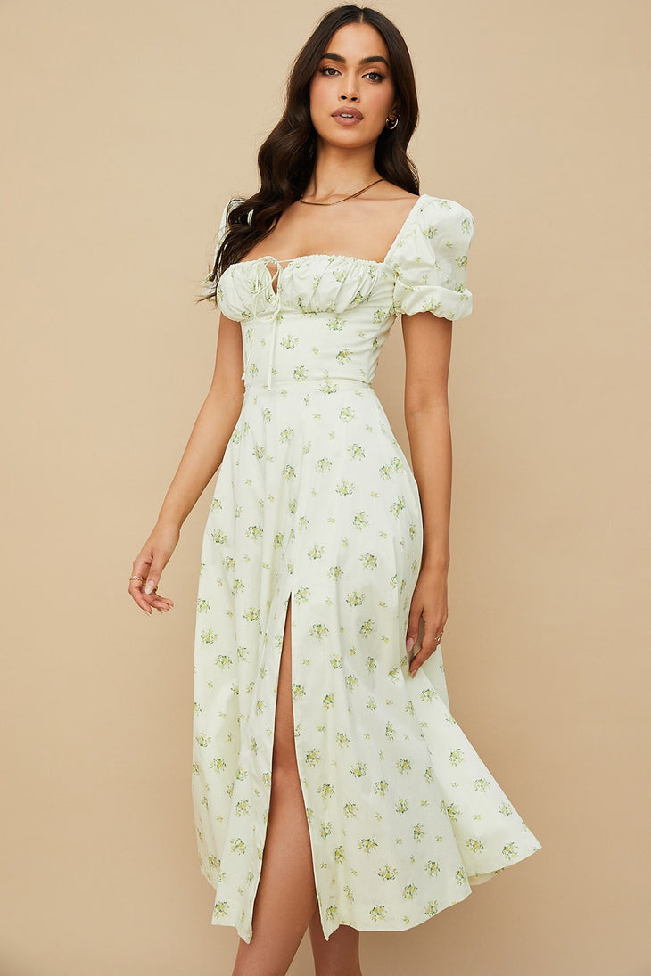 Woman wearing ivory floral puff sleeve midi dress with thigh slit — House of CB | Endless UAE