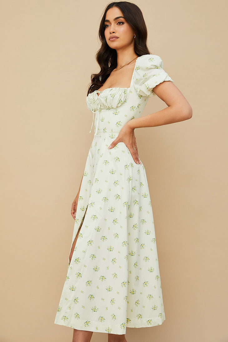 Woman wearing ivory floral puff sleeve midi dress with thigh slit — House of CB | Endless UAE