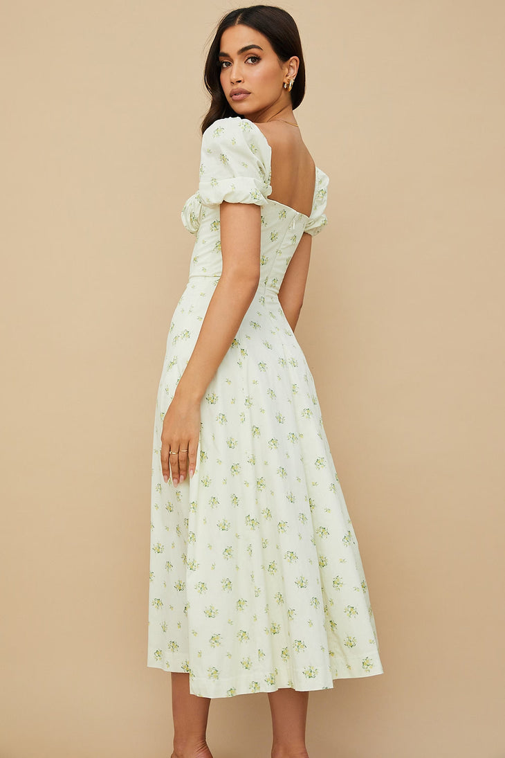 Woman wearing ivory floral puff sleeve midi dress with thigh slit — House of CB | Endless UAE