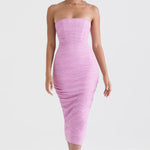 Model wearing pink strapless bodycon midi dress with ruched texture and corset styling for evening occasions — House of CB | Endless UAE