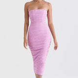 Model wearing pink strapless bodycon midi dress with ruched texture and corset styling for evening occasions — House of CB | Endless UAE