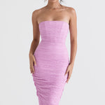 Model wearing Tana pink strapless corset midi dress with textured ruched fabric and figure-hugging silhouette — House of CB | Endless UAE