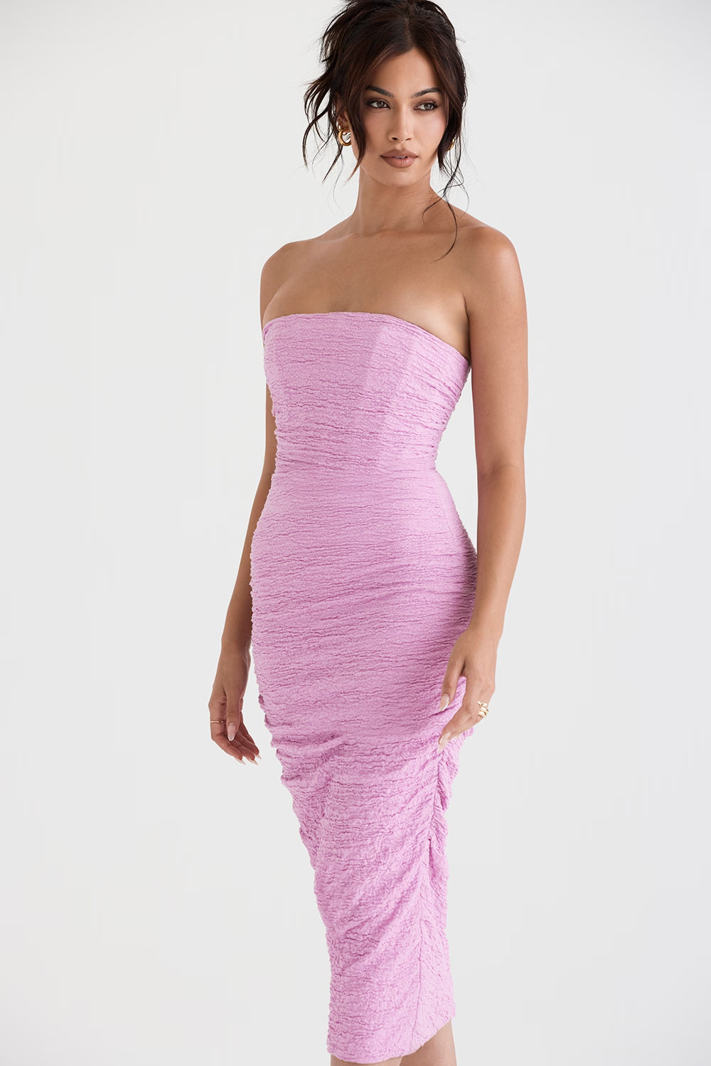 Model wearing pink strapless corset midi dress with textured fabric and body-hugging silhouette — House of CB | Endless UAE