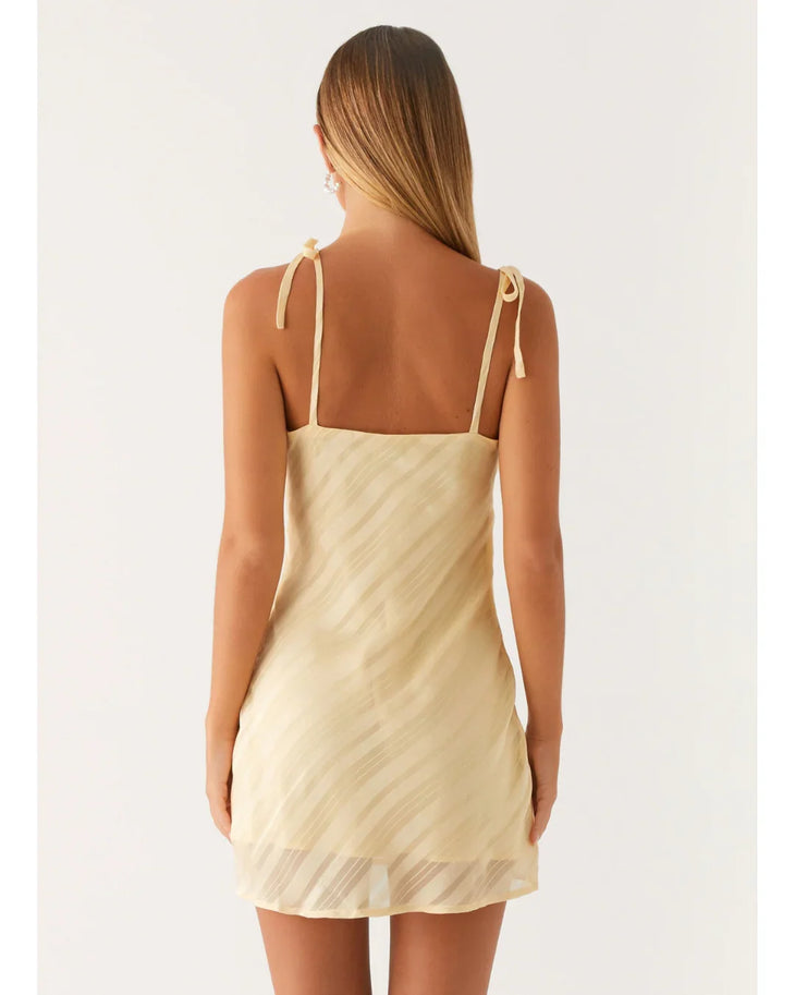 Cream tie-shoulder mini dress with wrap front and diagonal pleats — Peppermayo | Endless UAE