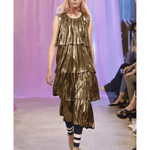 Metallic gold tiered plisse party dress with striped leggings on runway model — Baum Und Pferdgarten | Endless UAE