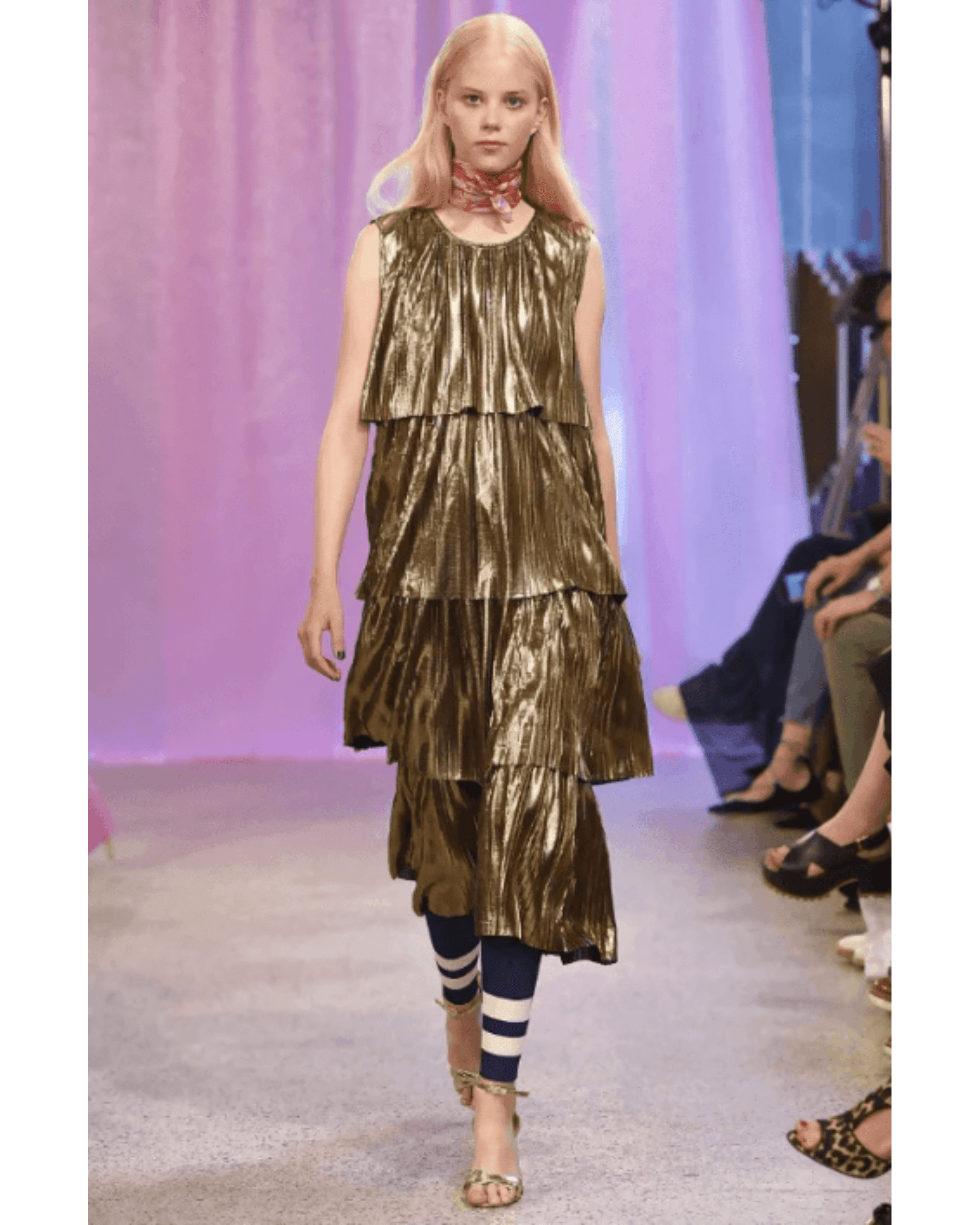 Metallic gold tiered plisse party dress with striped leggings on runway model — Baum Und Pferdgarten | Endless UAE