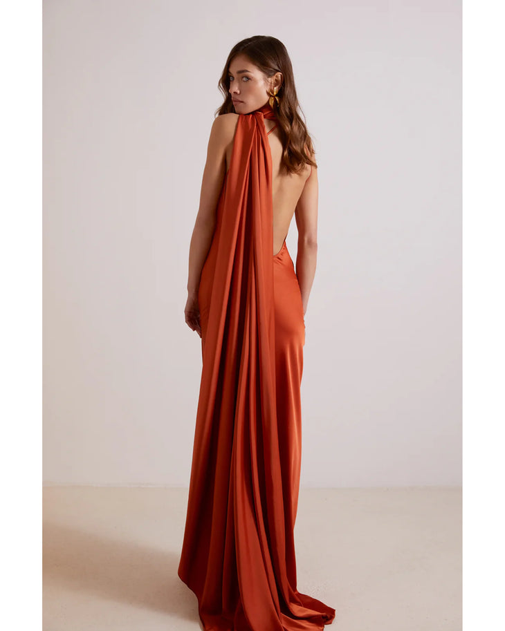 Elegant burnt orange backless maxi dress with draped halter neckline and flowing train — Kaoa | Endless UAE