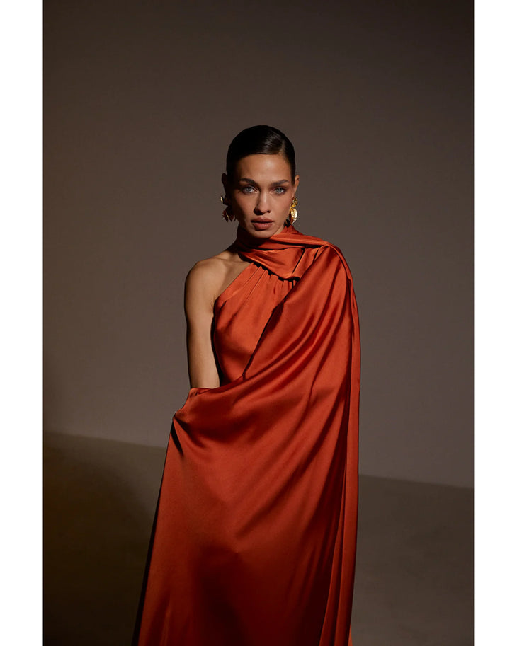 Elegant one-shoulder rust orange satin maxi dress with draped detailing and asymmetric neckline — Kaoa | Endless UAE