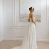 Elegant strapless wedding dress with flowing train and fitted bodice in minimal white design — You&I Bridal | Endless UAE