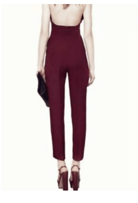 Rear view of woman wearing plum halter tailored jumpsuit with high waist and tapered legs, holding black clutch — Gucci | Endless UAE