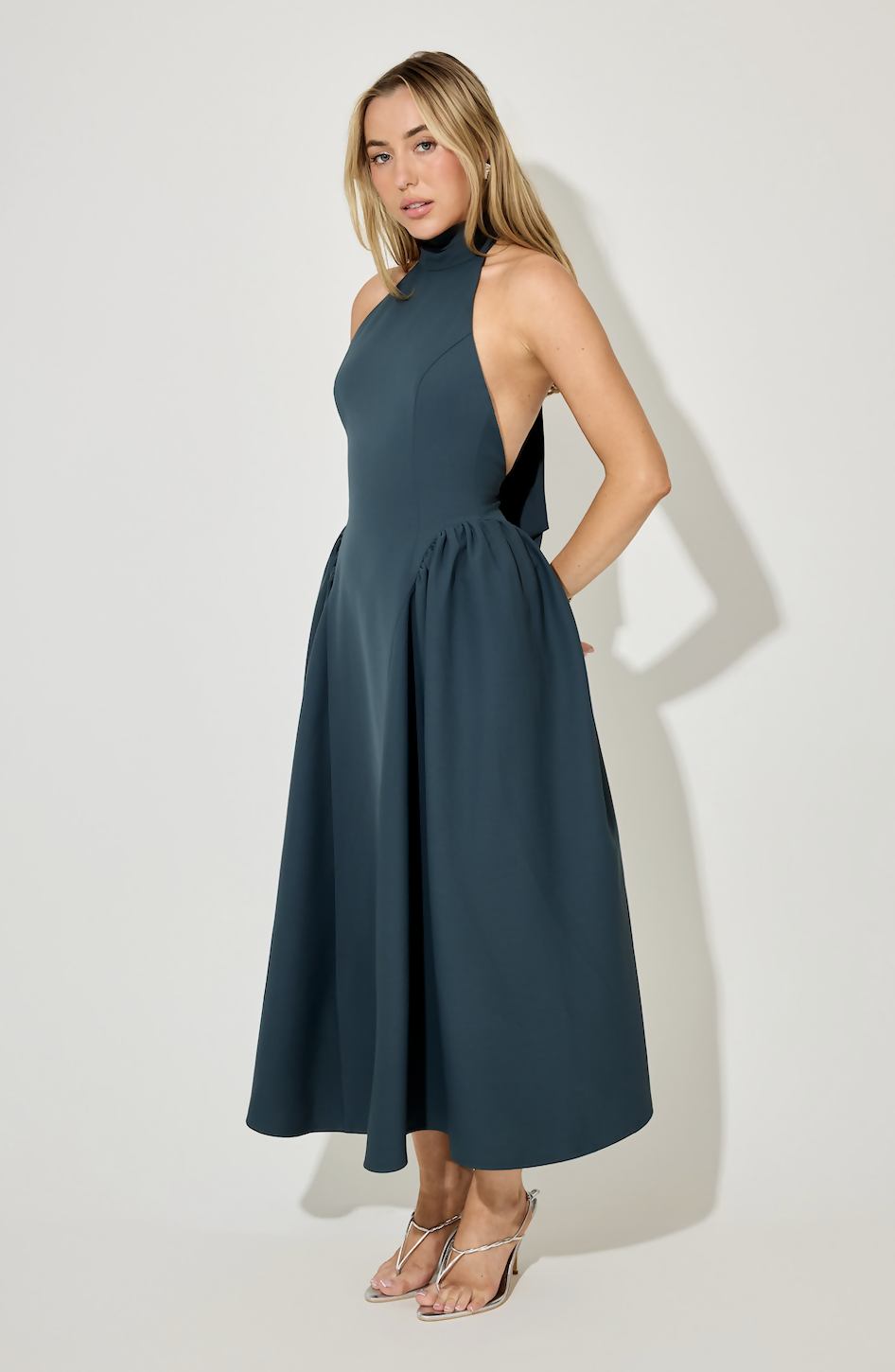 Elegant teal halter neck midi dress with gathered skirt detail and open back design — Oddmuse | Endless UAE