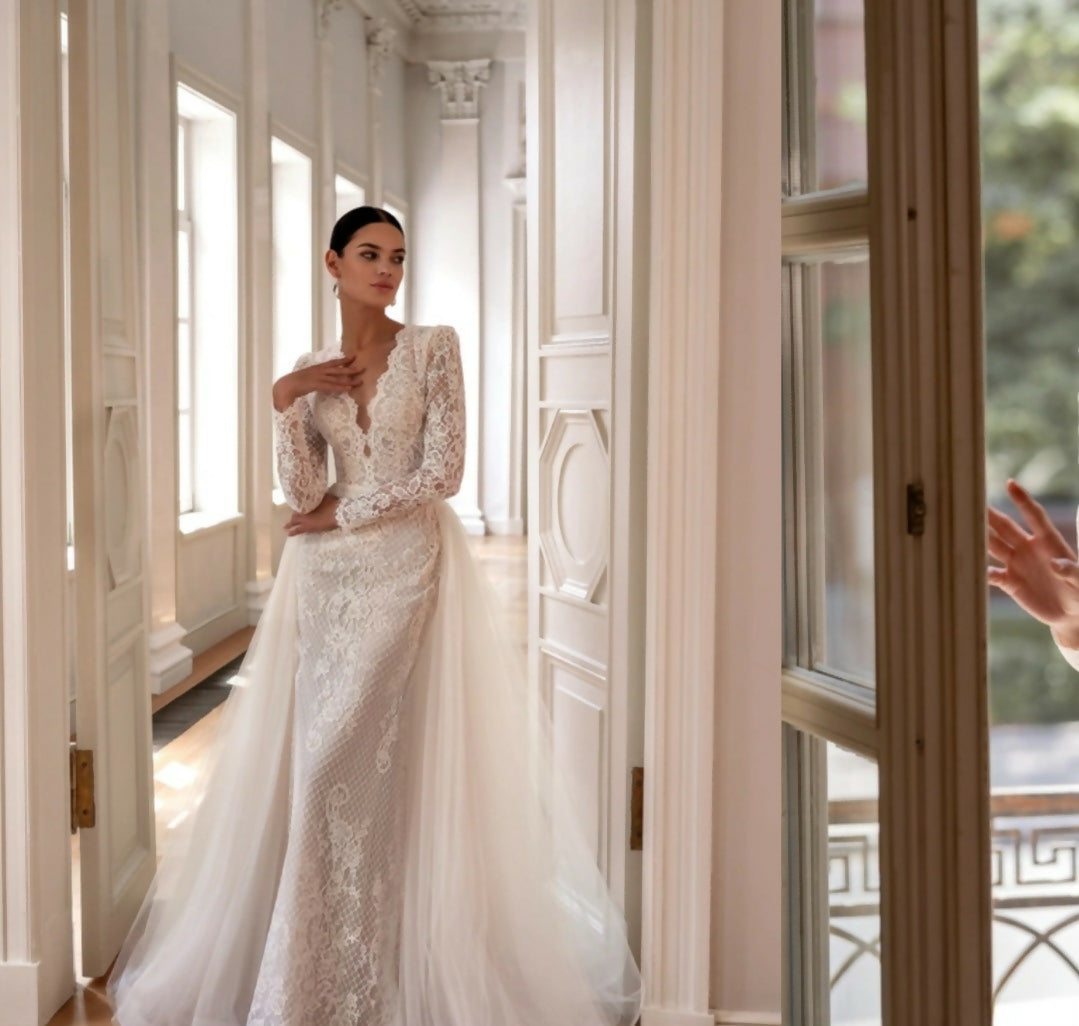 Elegant white lace wedding dress with long sleeves and flowing tulle train — Tatiana Kaplun | Endless UAE