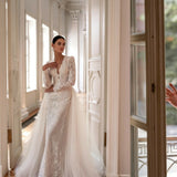 Elegant white lace wedding dress with long sleeves and flowing tulle train — Tatiana Kaplun | Endless UAE