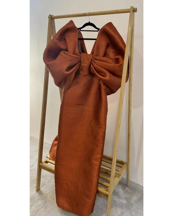 Woman wearing vibrant orange Grace 3D Shoulder Bow gown with dramatic back tail — Anaya Collection | Endless UAE