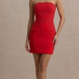 Woman wearing a strapless red mini dress with black heels, featuring a fitted silhouette and straight neckline — Club L | Endless UAE