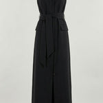 Woman wearing black sleeveless belted maxi dress by the seaside — LA Collection | Endless UAE