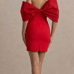 Red off-shoulder mini dress with dramatic oversized bow detail at back, fitted silhouette and center back slit — Club L | Endless UAE