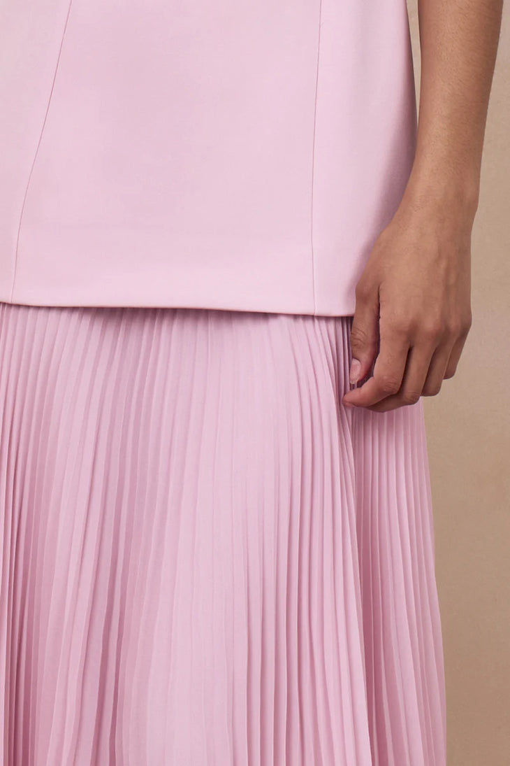 Woman wearing light pink sleeveless boat-neck maxi dress with pleated skirt — Club L London | Endless UAE