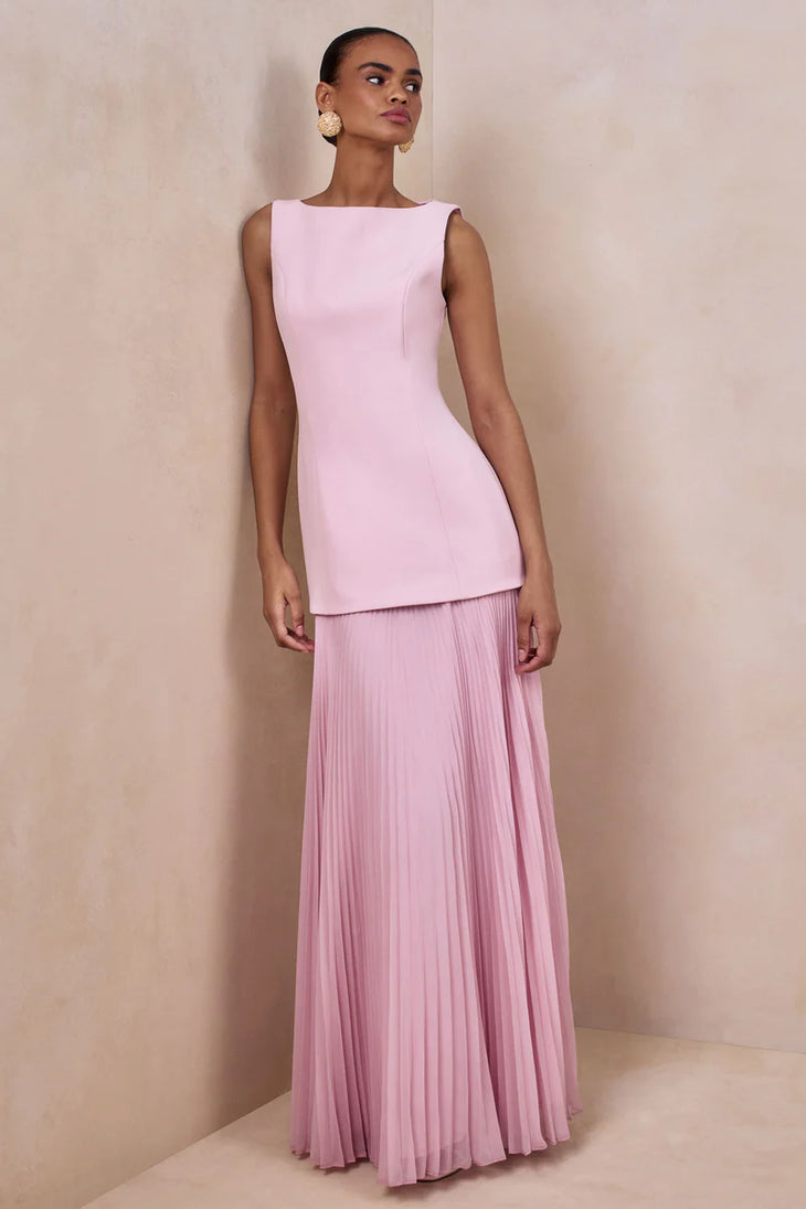 Woman wearing light pink sleeveless boat-neck maxi dress with pleated skirt — Club L London | Endless UAE