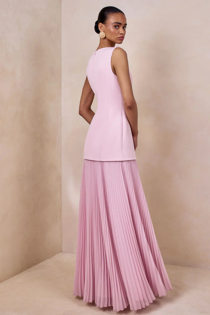 Woman wearing light pink sleeveless boat-neck maxi dress with pleated skirt — Club L London | Endless UAE