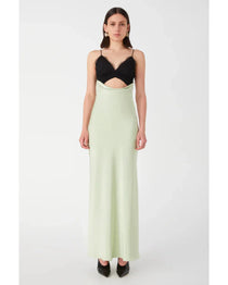 Woman wearing black and sage green color-block satin maxi dress with cutout detail — Misha | Endless UAE