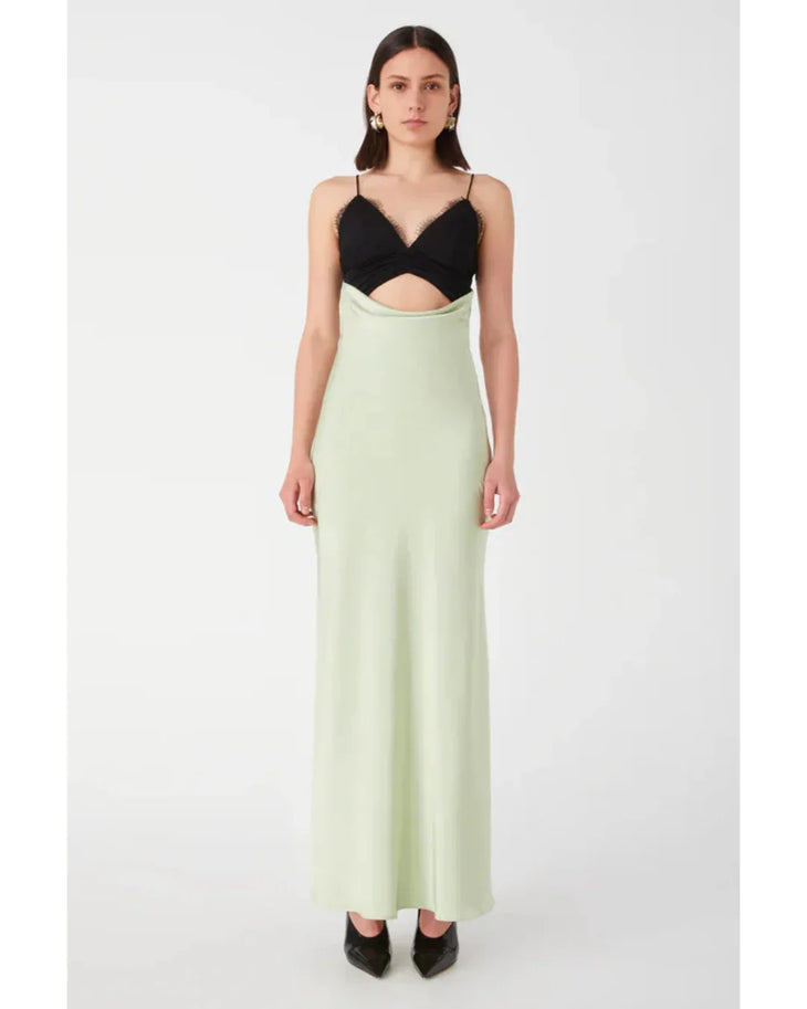 Woman wearing black and sage green color-block satin maxi dress with cutout detail — Misha | Endless UAE