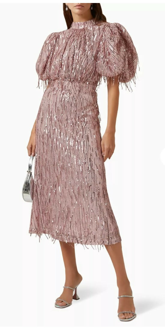 Woman wearing a dusty pink sequin fringe midi dress with puffed sleeves — Endless | Endless UAE