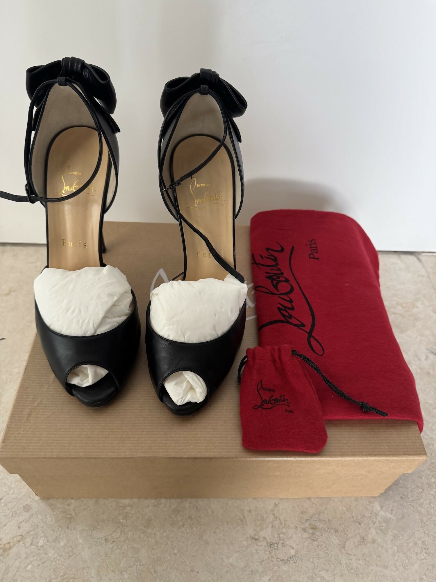 Black leather peep-toe platform pumps with bow detail and lace-up ankle straps — Christian Louboutin | Endless UAE