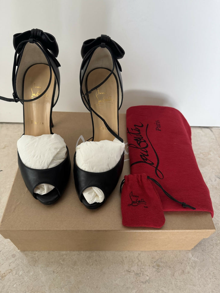 Black leather peep-toe platform pumps with bow detail and lace-up ankle straps — Christian Louboutin | Endless UAE