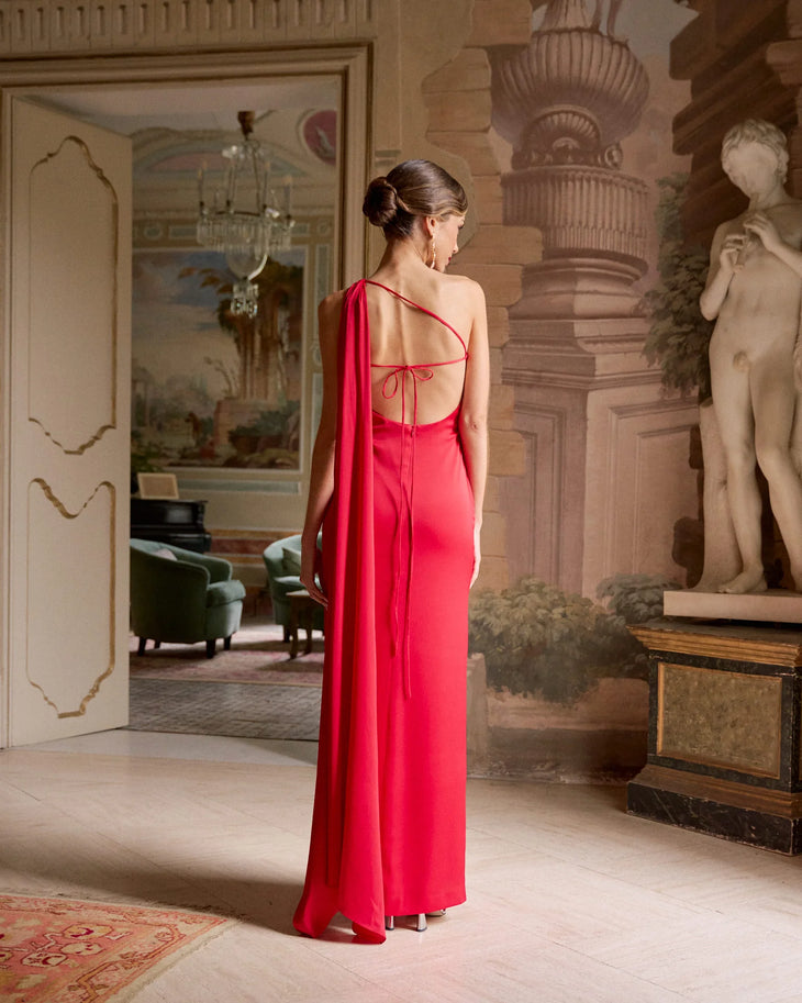 Elegant red one-shoulder gown with dramatic cape detail and open back, floor-length silhouette — Miphai | Endless UAE
