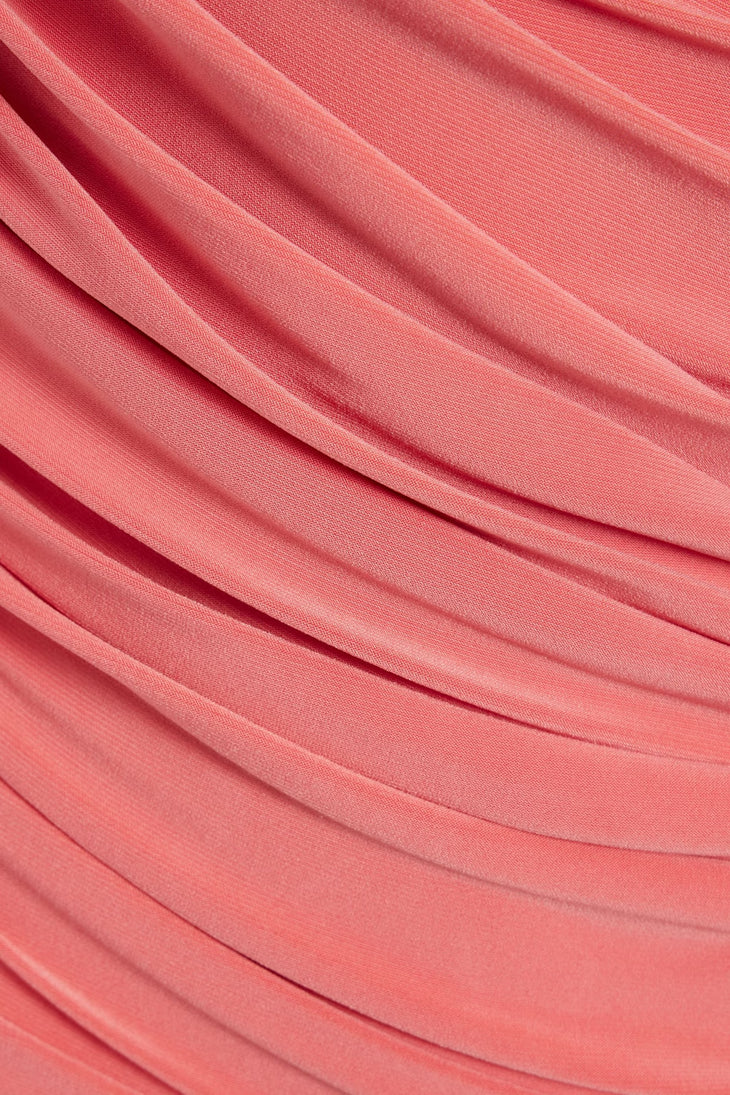 Woman wearing a coral one-shoulder ruched midi dress with metallic heels and clutch — Norma Kamali | Endless UAE