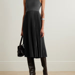 Elegant charcoal grey sleeveless midi dress with fitted bodice and pleated satin skirt, styled with black knee-high boots — Theory | Endless UAE